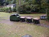 Image of a battery powered diesel parked with three skips